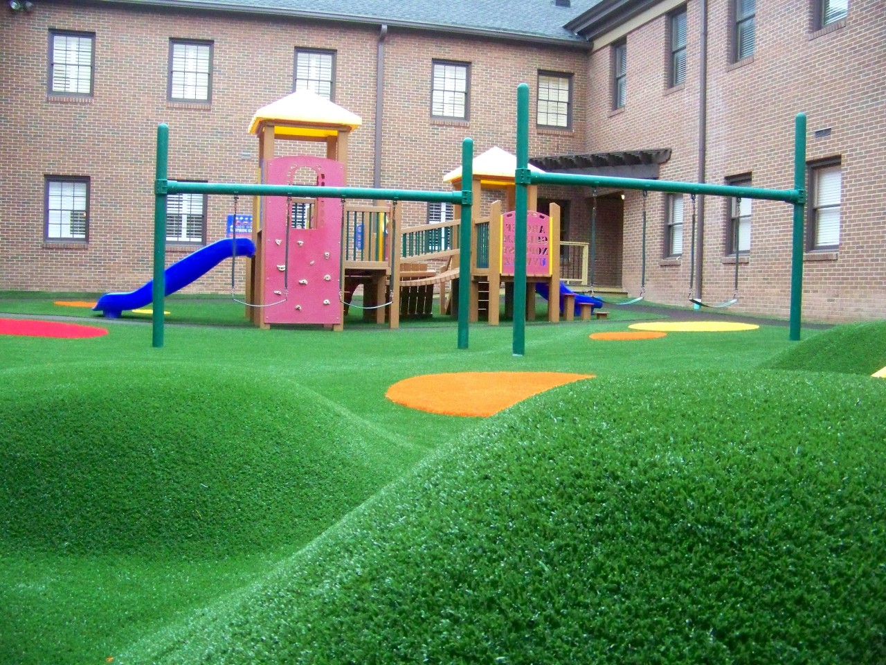 Hilly artificial turf playground by Southwest Greens of Augusta